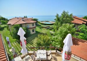 a view of a house with umbrellas on a balcony at Club Residence at BlackSeaRama Golf in Balchik