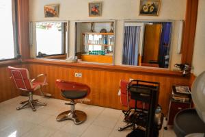 a barber shop with three chairs and two windows at Hotel Indra Toraja in Rantepao