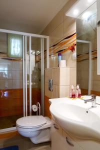 a bathroom with a white toilet and a sink at Magyar Apartmanház IV. in Zalakaros