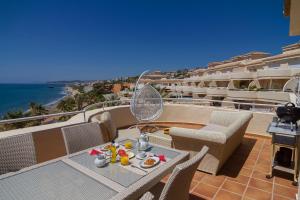エステポナにあるEl Mirador De Bermuda Beachのテーブルと椅子、海の景色を望むバルコニー