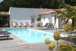 a swimming pool in front of a villa at Hotel L'Océan in Le Bois-Plage-en-Ré +51 photos