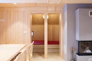 a sauna with a red bed in a room at Koča Predilnica Velika Planina in Kamniška Bistrica