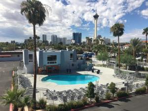 a swimming pool with a view of the city at Super 8 by Wyndham Las Vegas North Strip/Fremont St. Area in Las Vegas
