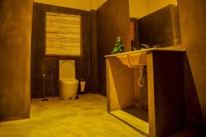 a bathroom with a sink and a toilet at Canaya Boutique Villa in Galle +22 photos