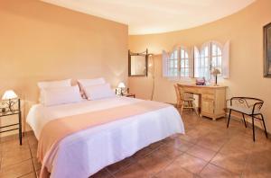 a bedroom with a large bed and a desk at Villa Tranquilla in Estepona +37 photos