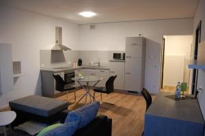 a kitchen and living room with a table and chairs at Boardinghouse-Niedernberg in Niedernberg