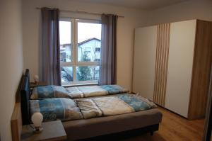 Postel nebo postele na pokoji v ubytování Boardinghouse-Niedernberg