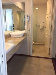 a bathroom with a shower and a sink and a toilet at Hotel Cervantes in Mendoza