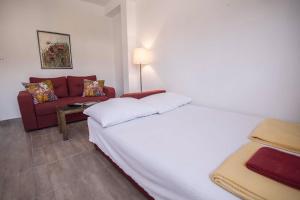 a hotel room with a bed and a couch at Sky Apartment in Trebinje +4 photos