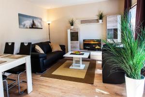 ein Wohnzimmer mit einer Couch und einem Tisch in der Unterkunft Strandfeeling in Dahme