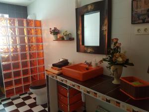 a bathroom with a red sink and a toilet at Las Tres Herraduras in Artazu