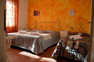 Postel nebo postele na pokoji v ubytování Agriturismo La Spiga