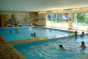 a group of people swimming in a swimming pool at Ferienpark Wehrda GmbH in Wehrda