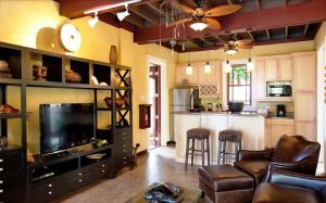 a living room with a couch and a television at Hermosa Cove Villa Resort & Suites in Ocho Rios