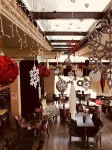 a restaurant with tables and chairs and decorations at Yiannis Apartments in Ioannina