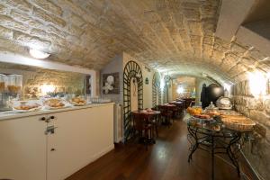 a kitchen and dining room with a stone ceiling at Prince Monceau in Paris