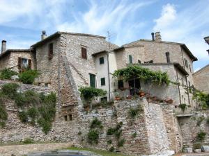 an old stone building with plants on it at Residence Casa Berti in Spello
