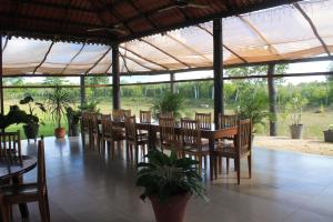 a dining room with tables and chairs under a tent at Real Primaveras Campestre in Escárcega