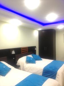 Postel nebo postele na pokoji v ubytování Hotel de las Américas - Ambato