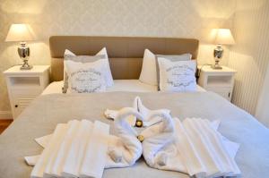 a bed with white towels on top of it at Villa Strandblick 11 in Zingst