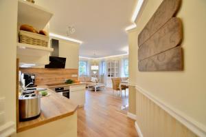 a kitchen with a wooden counter and a dining room at Villa Strandblick 11 in Zingst +11 photos