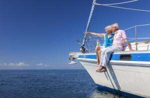 two people sitting on the bow of a boat in the water at Villa Strandblick 11 in Zingst