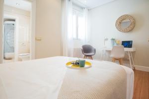 A bed or beds in a room at Heima Puerta del Sol - Plaza Santa Ana
