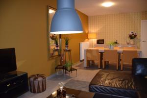 a living room with a couch and a dining room at Hotel Apartments Belgium 3 - HAB 3 in Geel