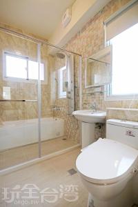 a bathroom with a toilet and a sink and a shower at Hai Bed and Breakfasts in Taitung City