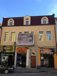 a building on the corner of a street with stores at Rooms Sonata in Kyustendil