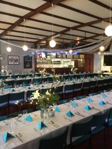 a banquet hall with white tables and chairs at Ship Inn Motel in Yarram