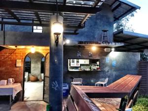 a patio with a wooden table and a dining area at Hip Home at Hod in Hot