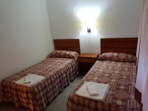 A bed or beds in a room at Apartamentos Olympia Center Még 37 kép
