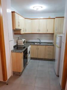 A kitchen or kitchenette at Apartamentos Olympia Center