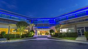 a building with blue lights on the front of it at Cathrin Hotel in Faliraki