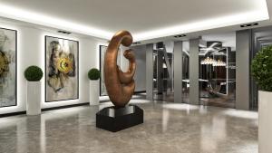a large bronze sculpture in a room with paintings at New Gate Hotel in Ankara