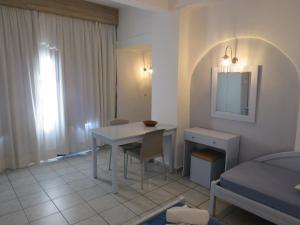 a small room with a table and a bed at Blue Beach Villas Apartments in Stavros