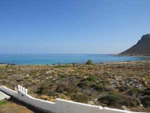 a boat on the beach with the ocean in the background at Blue Beach Villas Apartments in Stavros