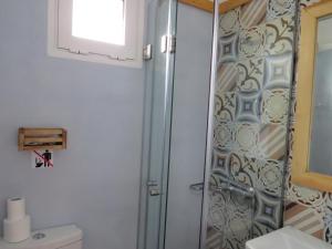 a shower in a bathroom with a toilet and a sink at Blue Beach Villas Apartments in Stavros