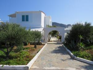 a walkway leading to a white house at Blue Beach Villas Apartments in Stavros