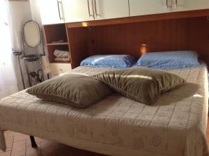 Cama ou camas em um quarto em terme di saturnia vacanze