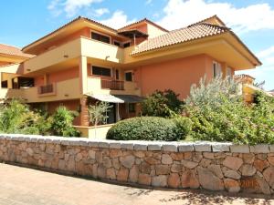 a house with a stone wall in front of it at Casa Gallo in Santa Marinella