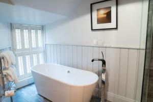 a bath tub sitting next to a window in a bathroom at The Beaumont Hexham in Hexham