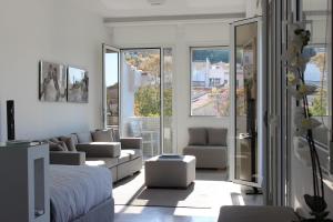 a living room with a bed and a couch at Best Views of Athens in Athens