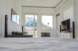 a white room with a bed and a living room at Best Views of Athens in Athens