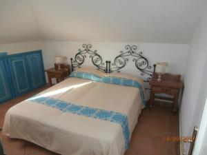 a bedroom with a bed, a desk, and a painting on the wall at Casa Gallo in Santa Marinella