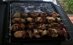 a pan of food cooking on a grill at Maison Cirmi in Szabadhidvég