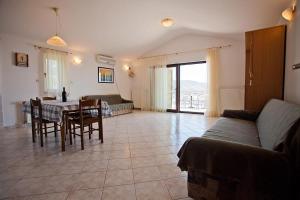 a living room with a table and a couch at The Ana Apartments in Komiža