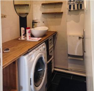 a washing machine in a small kitchen with a counter at Le studio d'Evelyne in Dieppe