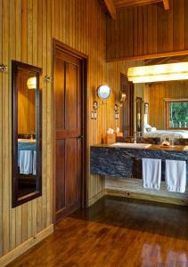 a bathroom with a sink and a large mirror at Las Lagunas Boutique Hotel in Flores